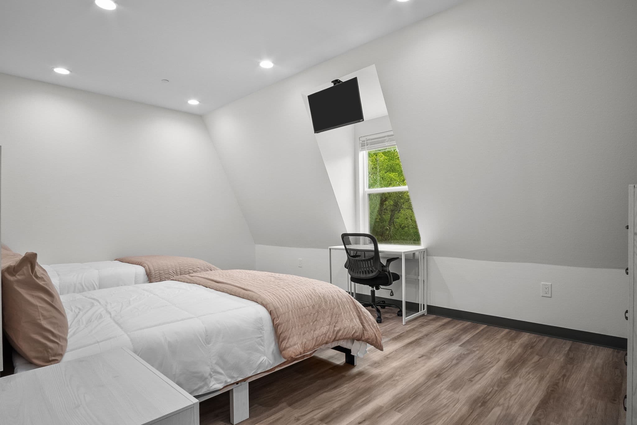 Semi-private bedroom with a desk and workspace
