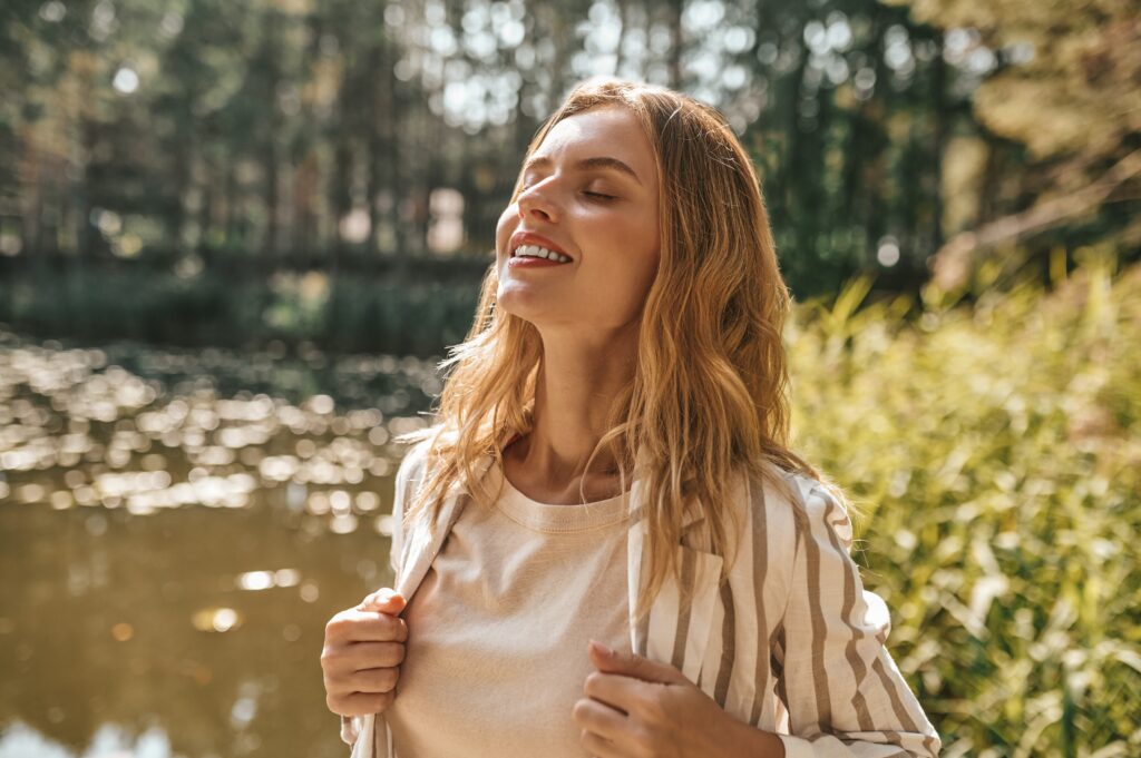 Woman breathing peacefully after going through the detox process, celebrating life without substance